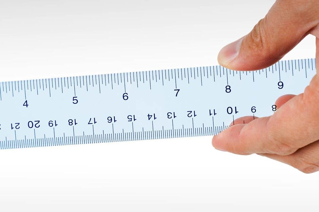 a ruler to measure the head of the penis before enlargement