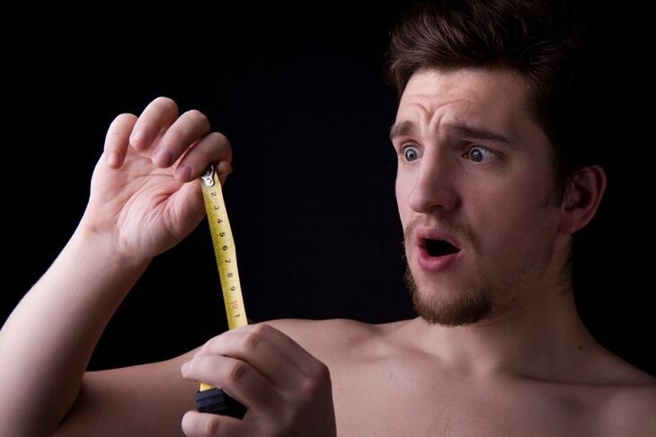 a man with a measuring tape measured his penis before an enlargement operation